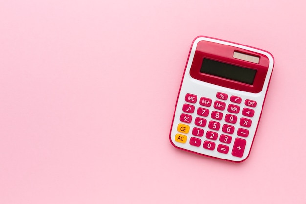 Free photo top view calculator on pink background