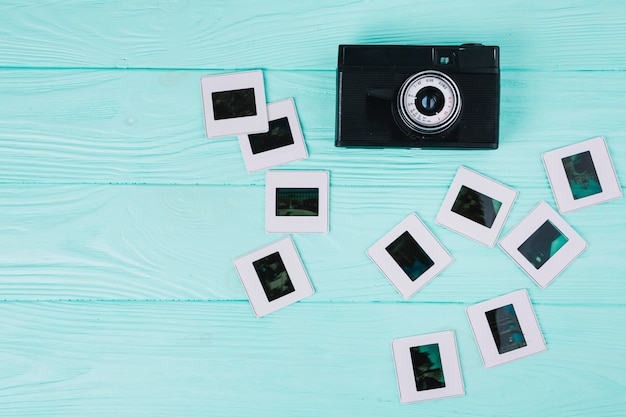 Free Photo top view camera with negatives on blue background