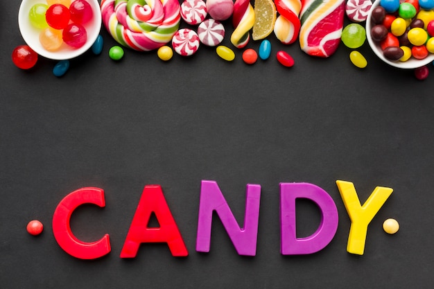 Free photo top view candy lettering with tasty sweets