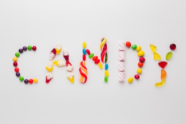 Free photo top view candy word written with sweets