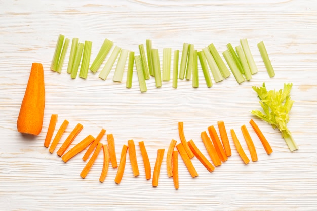 Free photo top view carrot and celery arrangement