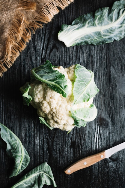 Free Photo top view cauliflower with leaves and knife