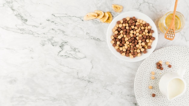 Top view cereal bowl and yogurt with copy-space