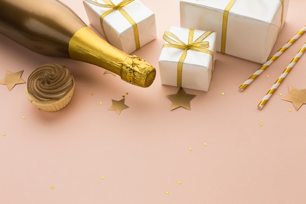 Free Photo top view champagne bottle with gifts