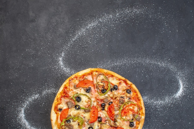 Top view cheese pizza with olives pepper and tomatoes on dark surface