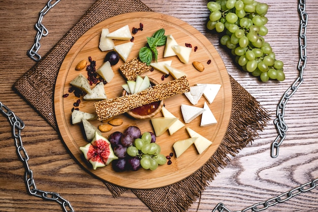 Free Photo top view cheese plate with grapes