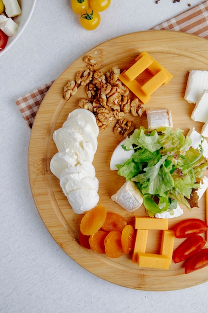 Top view of cheese plate with nuts on a table