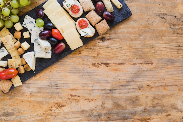 Free photo top view of cheese platters with grapes and tomatoes on table