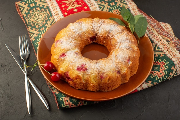 Free photo a top view cherry cake round formed inside brown plate on the dark desk cake biscuit sugar sweet