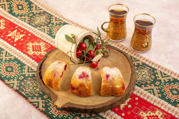 Free photo a top view cherry cake slices with tea on the pink desk cake biscuit sugar sweet