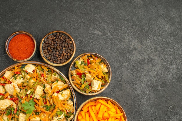 Top view chicken salad with vegetables on dark table diet salad health