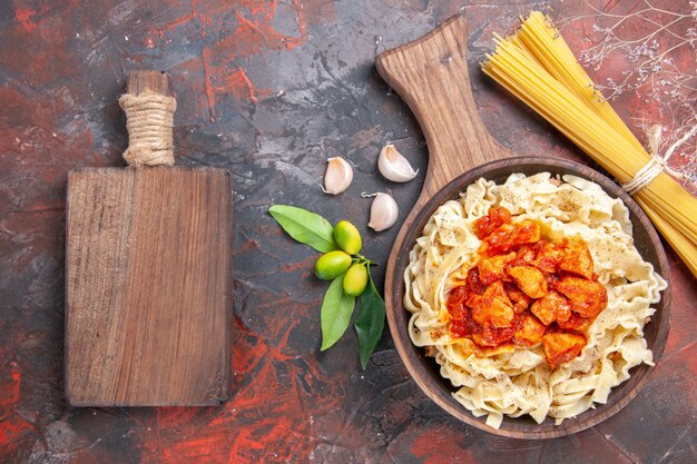 Top view chicken with dough pasta dish on dark floor dish dark pasta dough