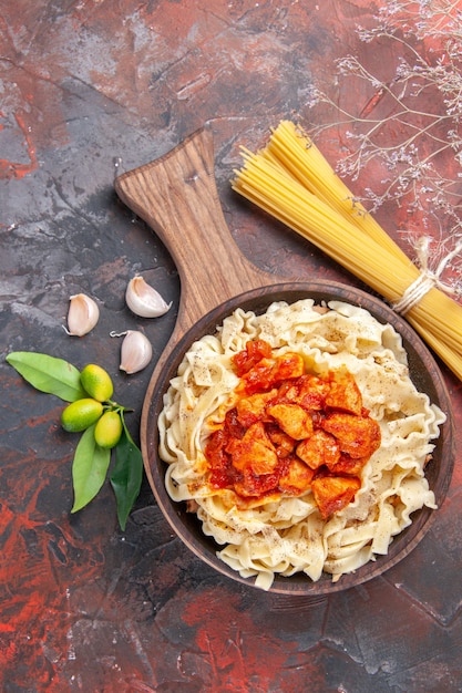 Top view chicken with dough pasta dish on a dark surface dish dark pasta dough