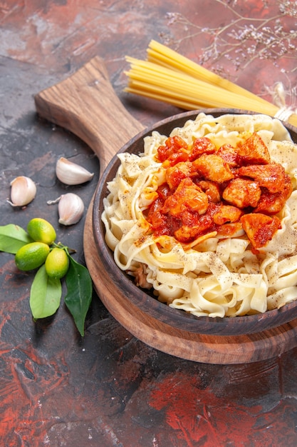 Free photo top view chicken with dough pasta dish on dark surface dish dark pasta dough