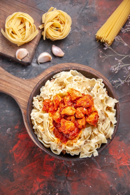 Top view chicken with dough pasta dish on a dark surface dough dish dark pasta