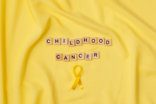 Free photo top view over childhood cancer awareness month background concepttoys,