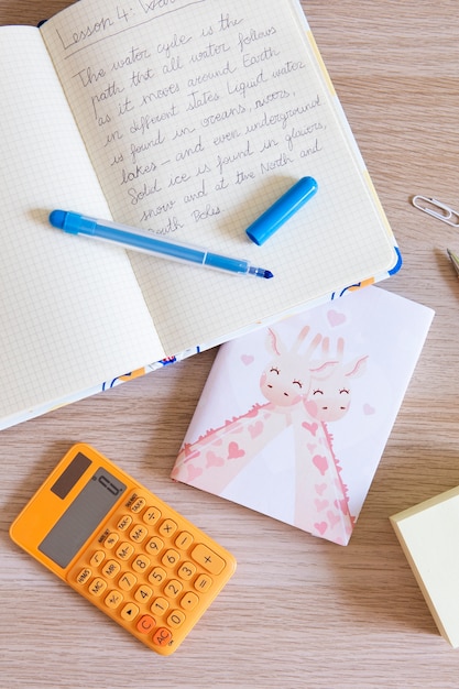 Free photo top view of children's desk with notebook and calculator