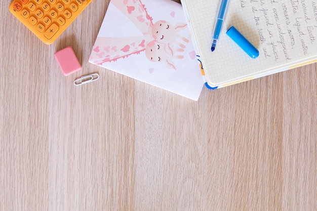 Free photo top view of children's desk with notebook and pen