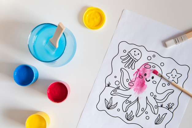 Free Photo top view of children's desk with paint and drawing