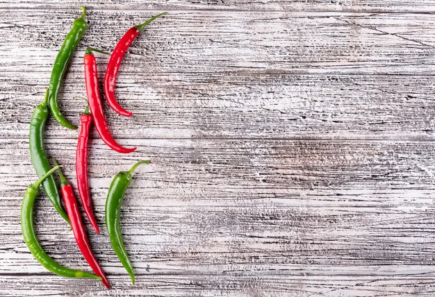 Top view chili pepper with copy space on right on white wooden