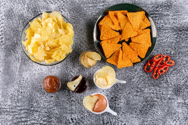 Free Photo top view chips in bowl with sauses and pepper on white stone  horizontal