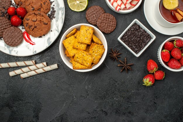 Top view choco biscuits with candies and tea