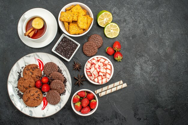 Top view choco biscuits with candies and tea