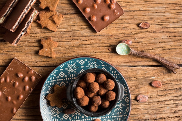 Top view chocolate bars and candies with cookies