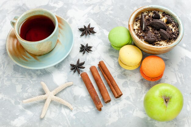 Top view chocolate cookie dessert with french macarons and tea on light-white desk cookie sweet bake sugar pie biscuit