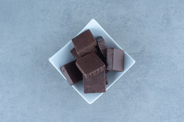 Top view of chocolate wafers in white bowl.