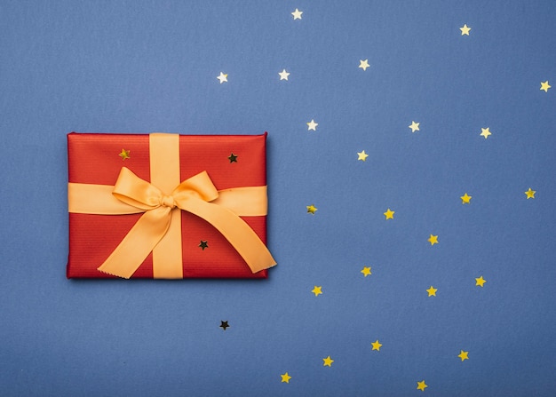 Top view of christmas box with golden stars and ribbon