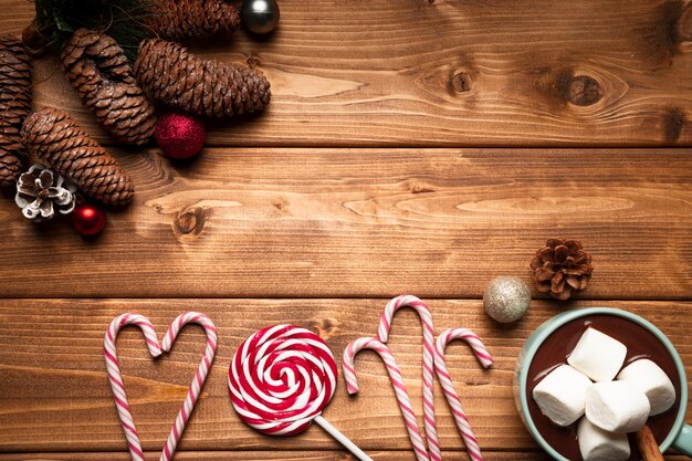 Top view christmas candy with wooden background