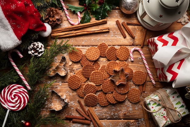 Top view christmas cookies with wooden background