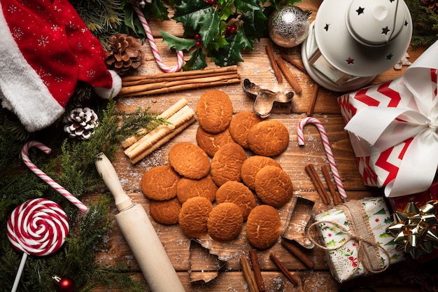 Top view christmas cookies with wooden background