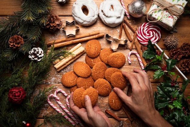 Top view christmas cookies with wooden background