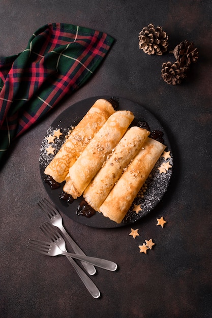 Top view of christmas crepes with pine cones