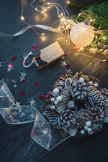 Top view of Christmas decorations and lights on the wooden table