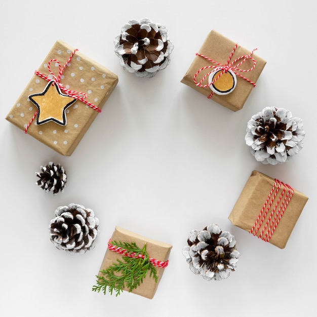 Top view of christmas gifts in circle with pine cones