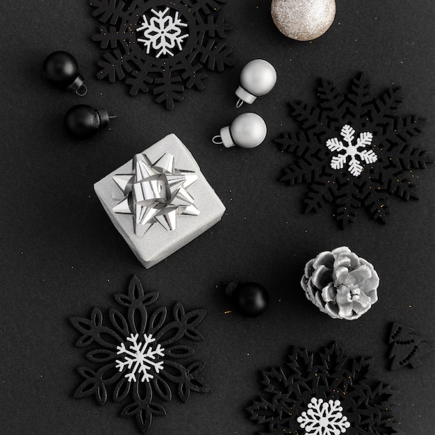 Free Photo top view of christmas ornaments with gift and pine cone