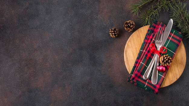 Free photo top view of christmas table arrangement with pine cones and copy space