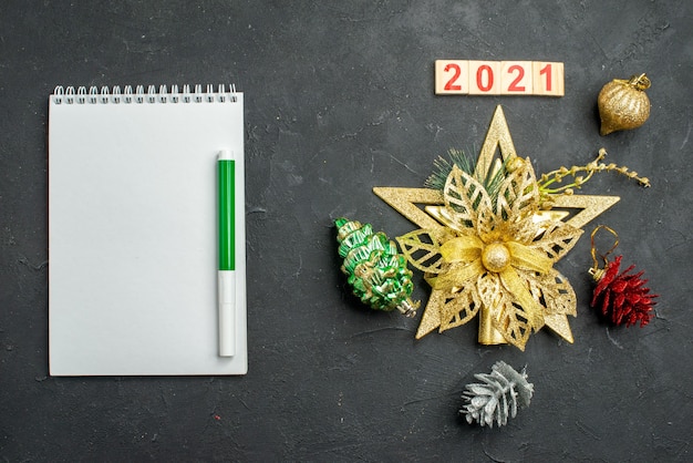 Free Photo top view christmas tree toys with notepad and number 2021, new year