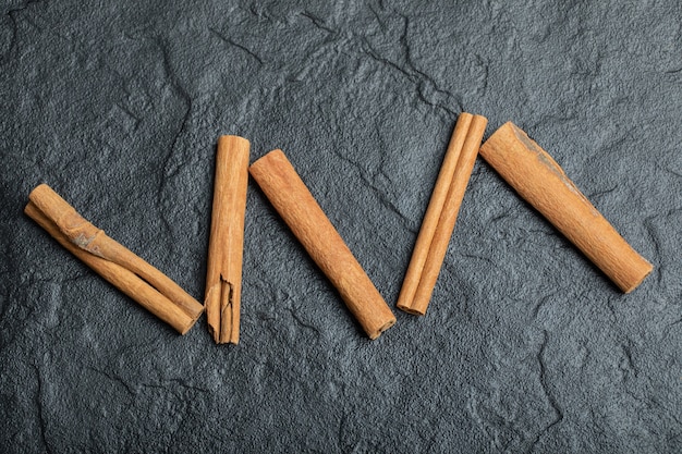 Free Photo top view of cinnamon sticks isolated on dark background. 