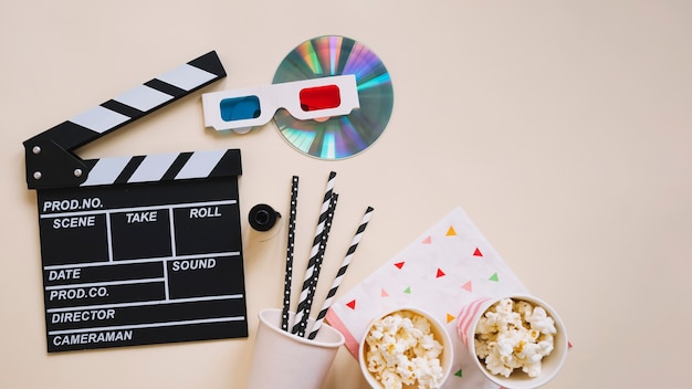 Top view of clapperboard and movie elements