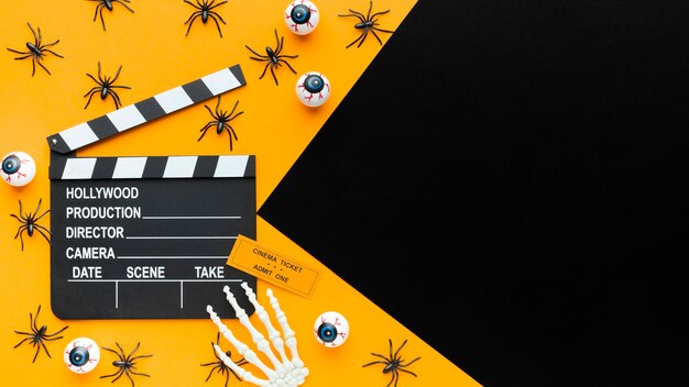 Top view clapperboard and spiders with copy space