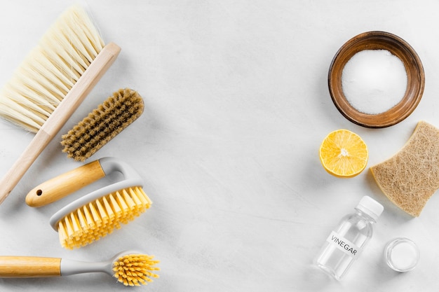 Top view of cleaning brushes with baking soda and lemon