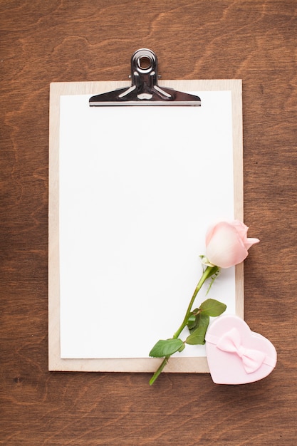 Top view clipboard with pink rose and gift