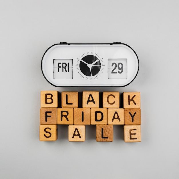 Top view of clock and black friday sale cubes