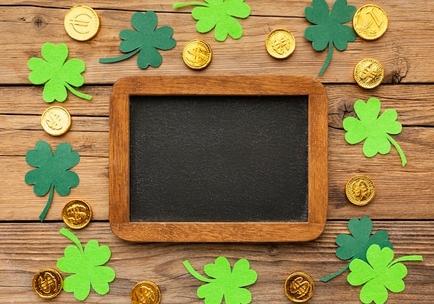 Free Photo top view clovers, coins and frame arrangement