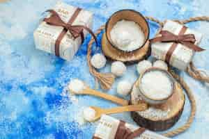 Free photo top view coconut balls rope bowls with coconut powder on blue white background