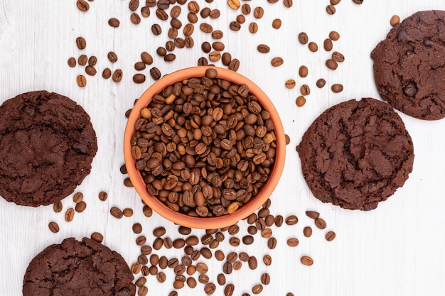 Free Photo top view coffee beans and chocolate cookies on white surface